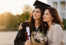 Мама обіймає доньку-випускницю з дипломом і квітами