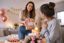 Friend giving a birthday gift during a warm surprise celebration at home