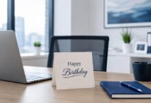 Professional happy birthday card on an office desk with laptop and notebook